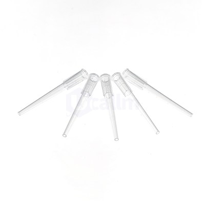 Group of clear plastic pipette tips arranged in a circular fan on a white background