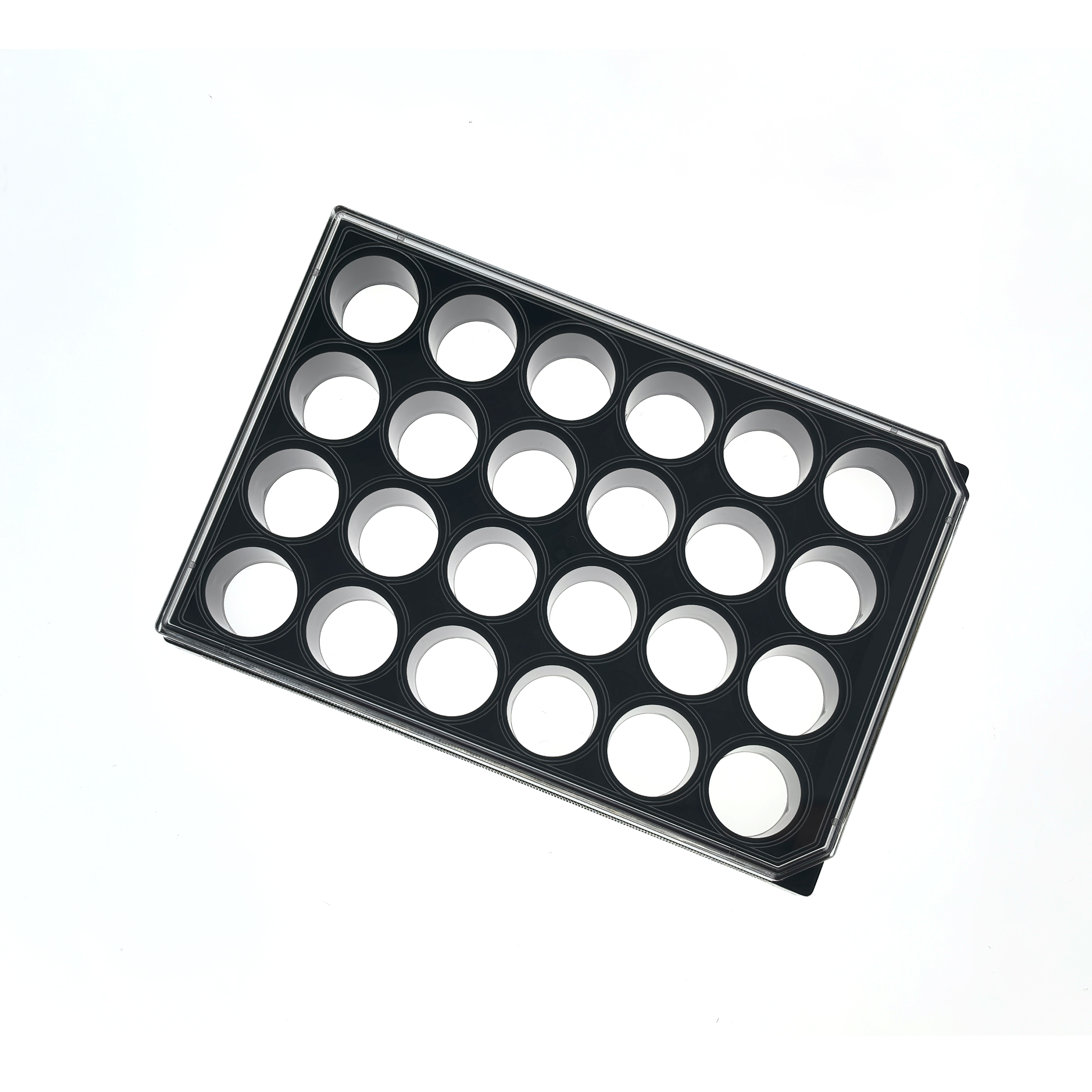 24 Well glass bottom plate (1) Angled view of a black muffin tin with round cups arranged in a grid including several empty circular holes