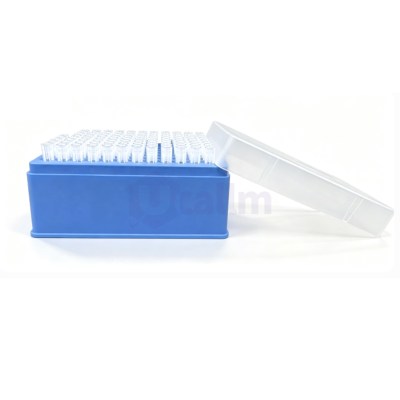 Blue rack holding numerous clear-capped microcentrifuge tubes or PCR tubes, with a transparent lid resting to the side in a lab setting.